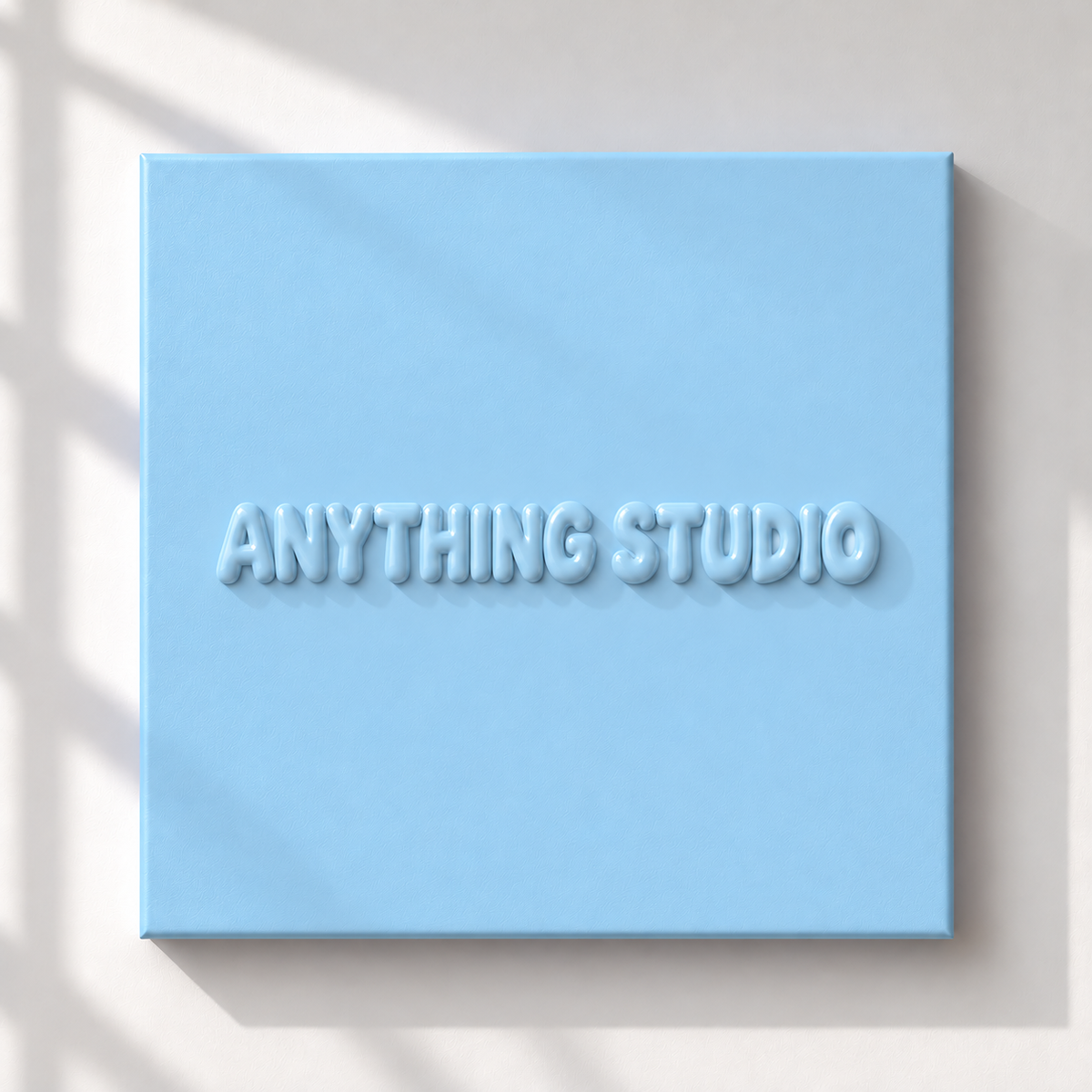 ANYTHING STUDIO sculptural lettering canvas in baby blue on a white wall