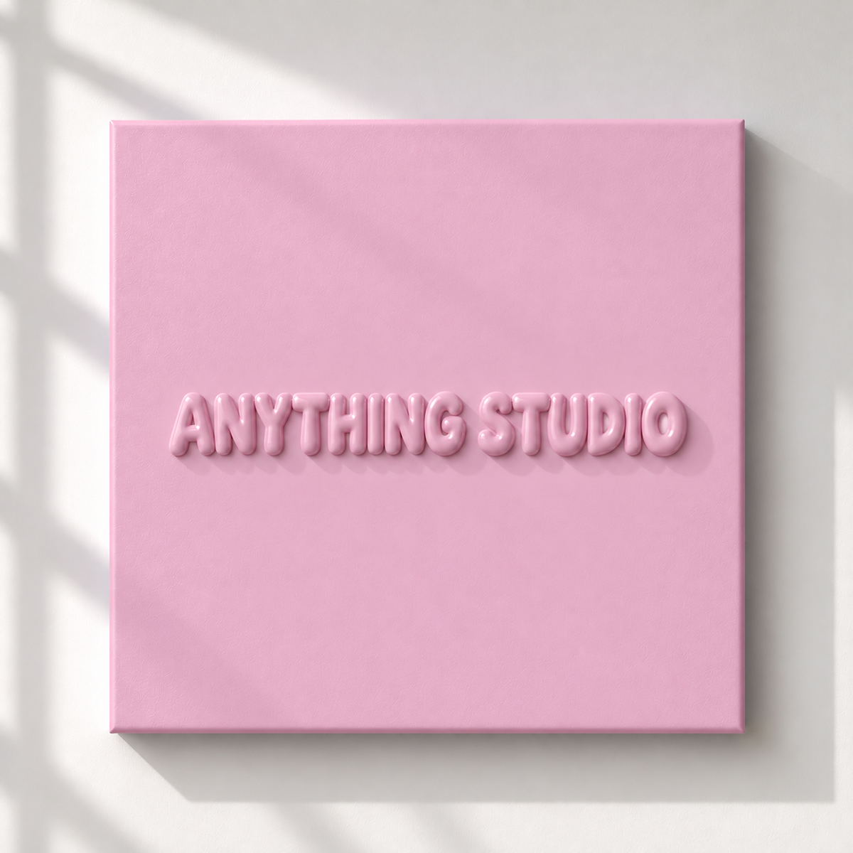 ANYTHING STUDIO sculptural lettering canvas in baby pink on a white wall