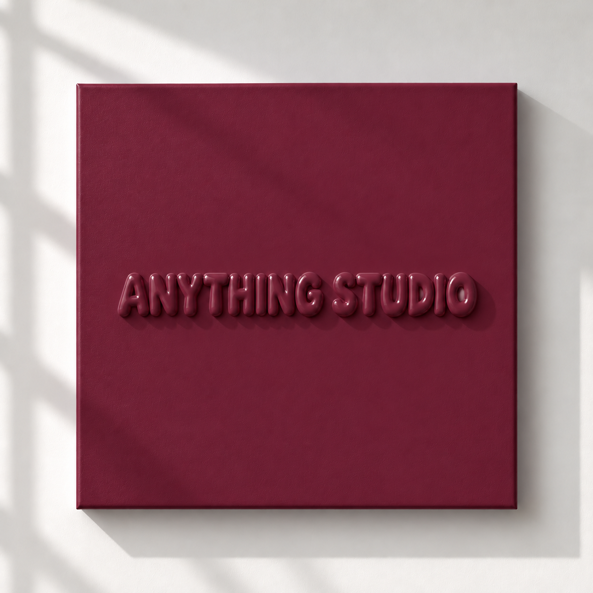 ANYTHING STUDIO sculptural lettering canvas in burgundy on a white wall