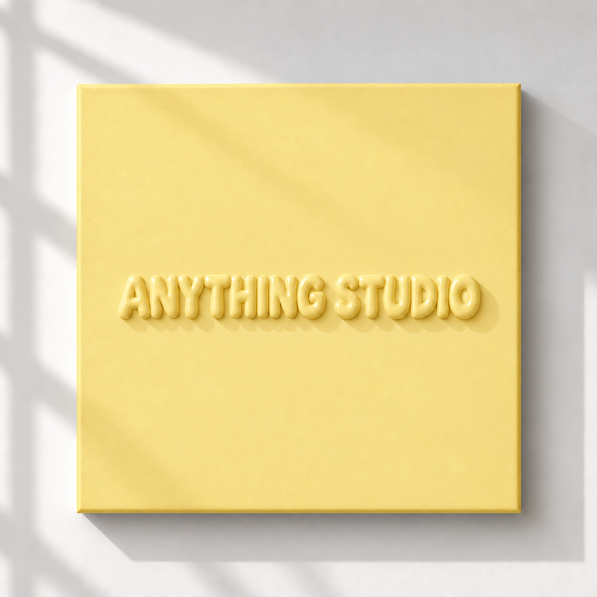 ANYTHING STUDIO sculptural lettering canvas in butter yellow on a white wall