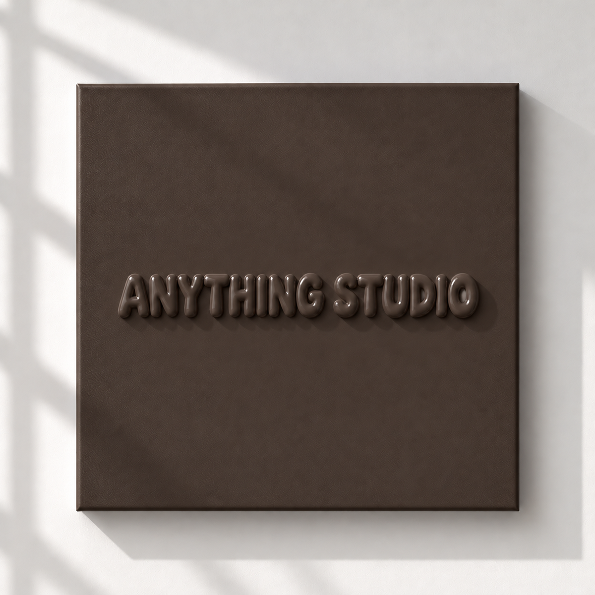ANYTHING STUDIO sculptural lettering canvas in chocolate brown on a white wall
