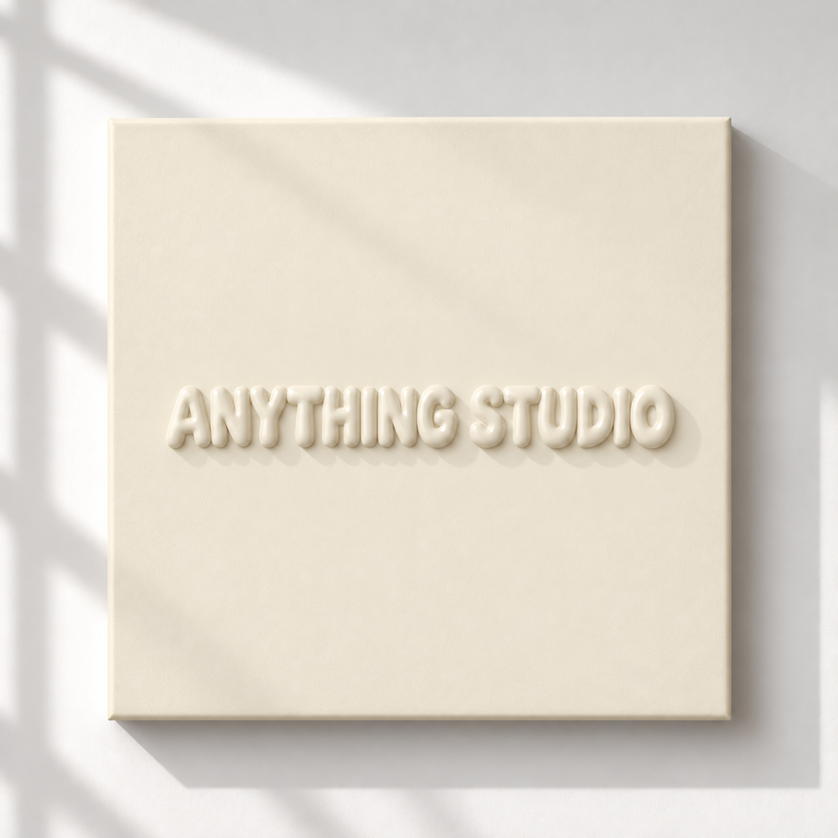 ANYTHING STUDIO sculptural lettering canvas in cream on a white wall
