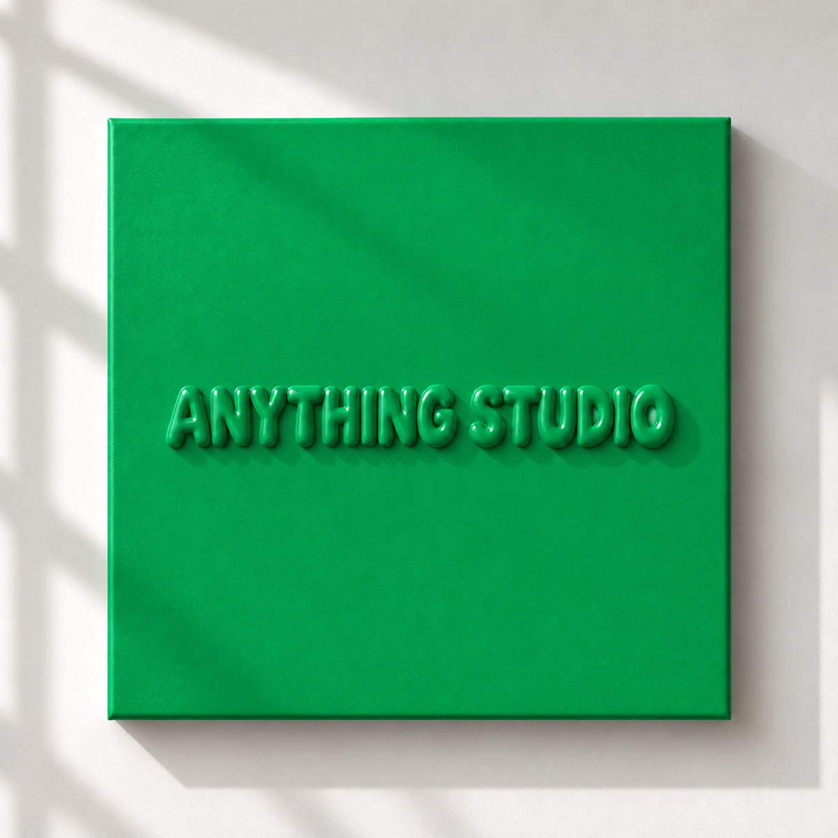 ANYTHING STUDIO sculptural lettering canvas in emerald green on a white wall