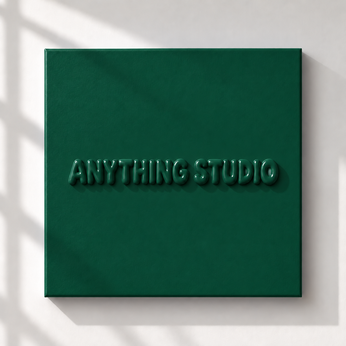 ANYTHING STUDIO sculptural lettering canvas in forest green on a white wall