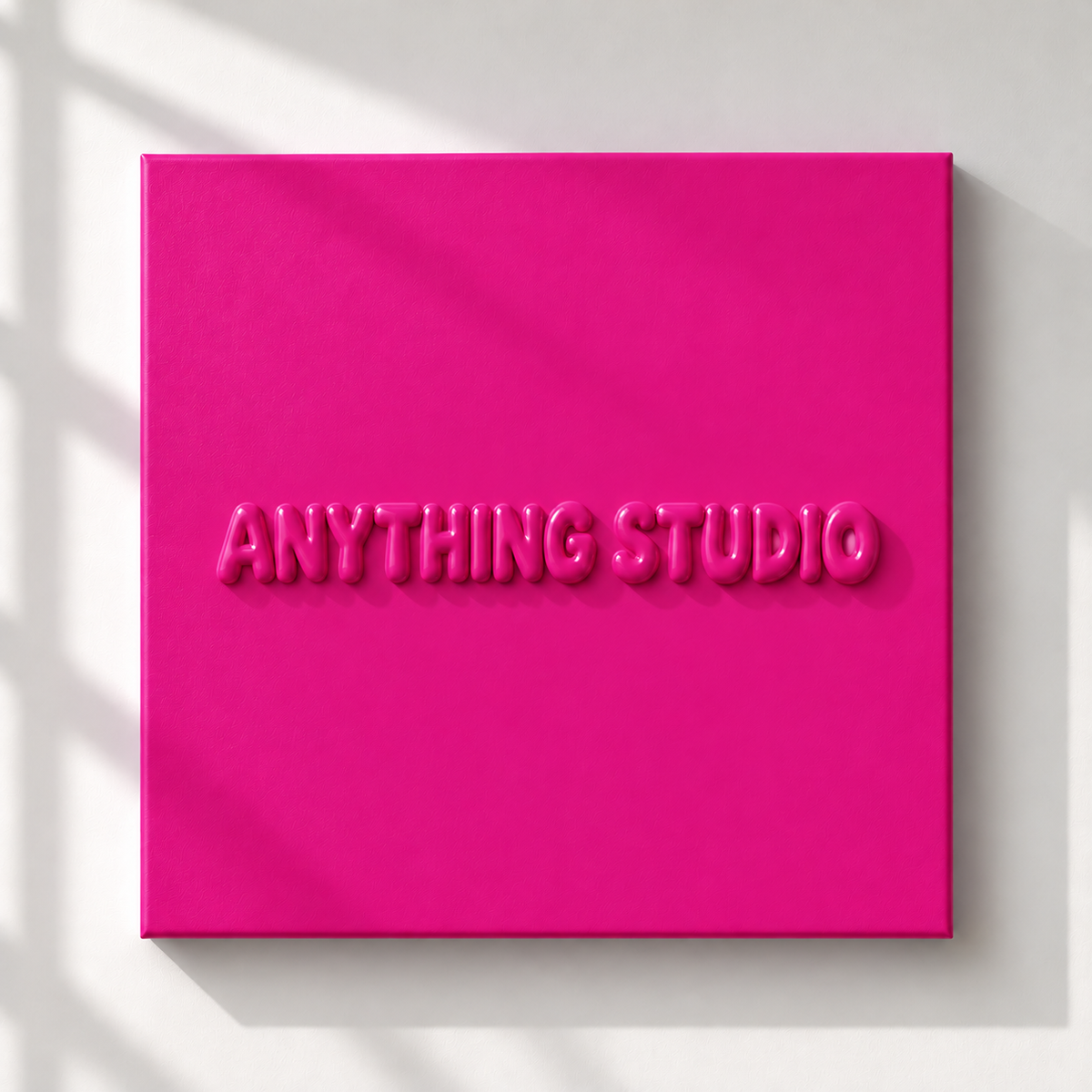 ANYTHING STUDIO sculptural lettering canvas in hot pink on a white wall