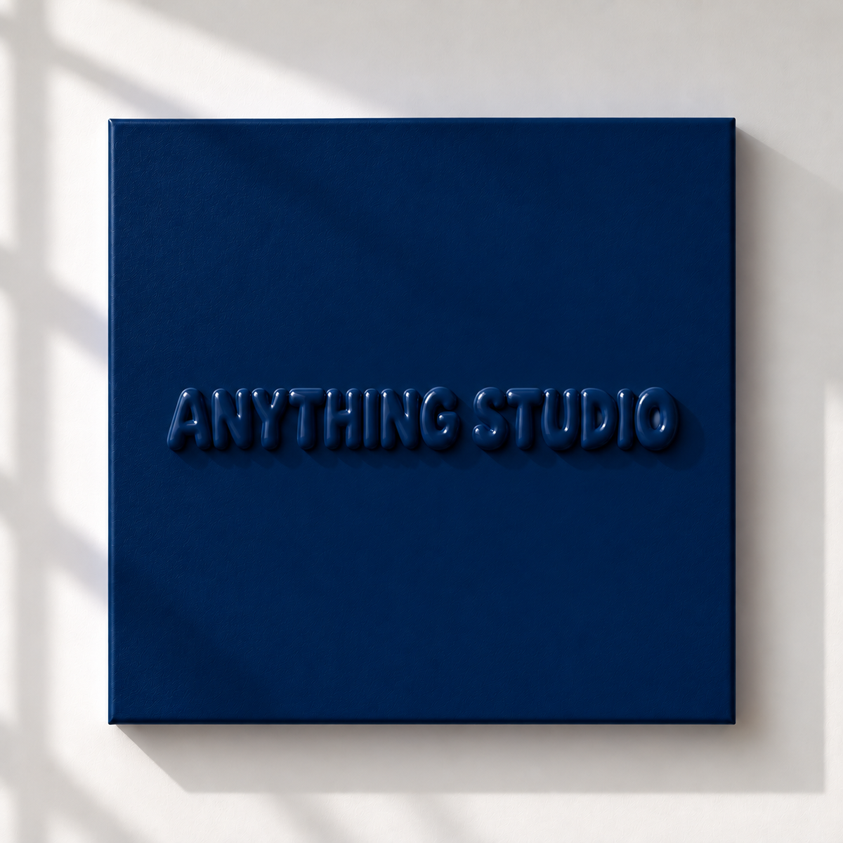 ANYTHING STUDIO sculptural lettering canvas in navy blue on a white wall
