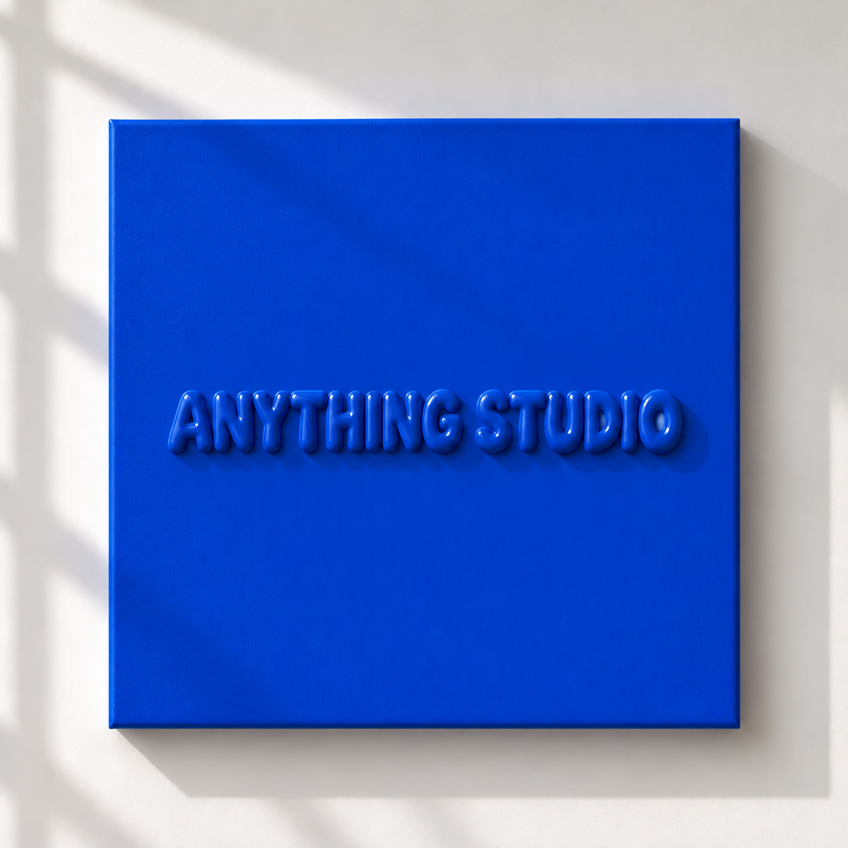 ANYTHING STUDIO sculptural lettering canvas in royal blue on a white wall