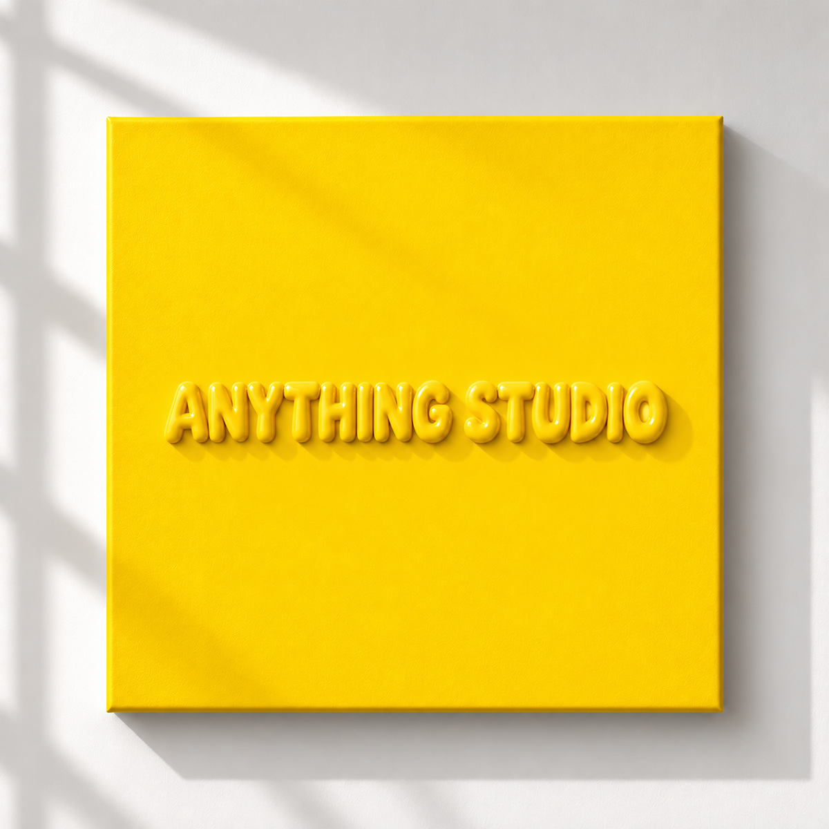 ANYTHING STUDIO sculptural lettering canvas in yellow on a white wall
